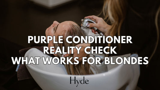 Blonde client with fresh highlights styled by a Hyde Salon stylist, holding purple conditioner.