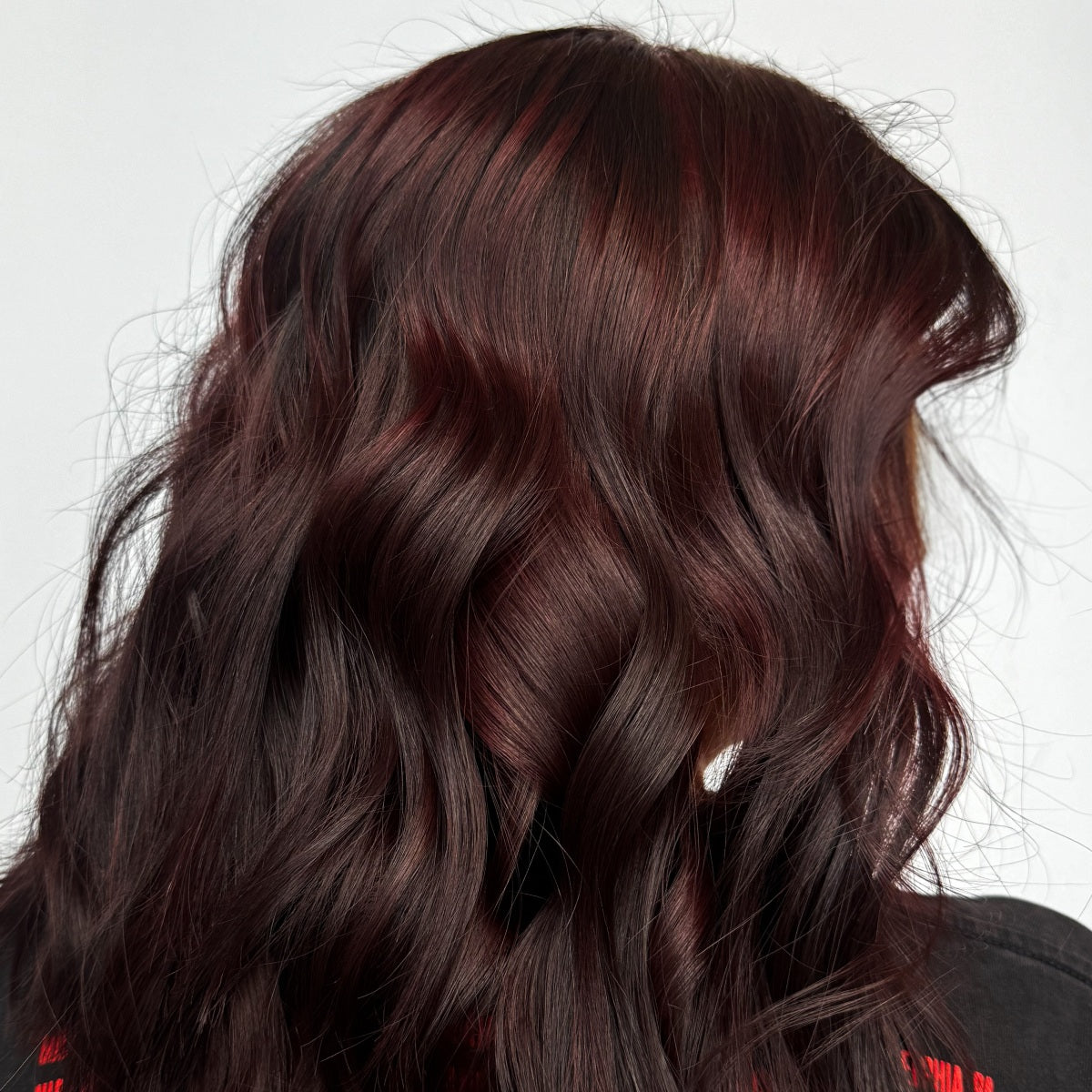 Hyde Salon Vista guest with rich burgundy red hair styled in soft waves