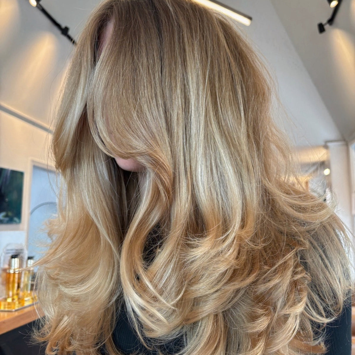 Hyde Salon Vista guest with long dimensional blonde hair styled in soft waves